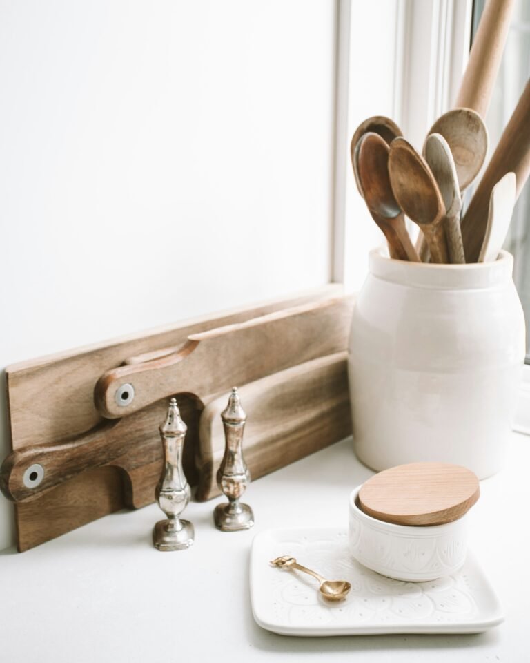 good days digital 68CDDj03rks unsplash Wooden kitchen cutting board, salt cellar, and wooden utensils on a kitchen counter for low-tox kitchen swaps.