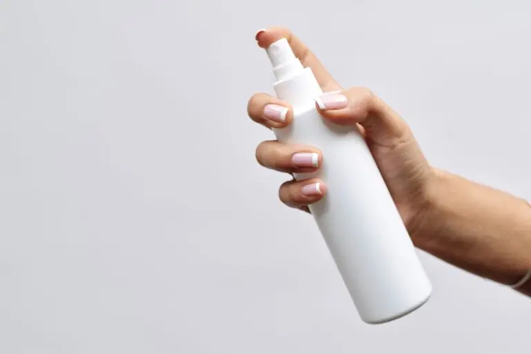 What does fragrance mean? Understanding fragrance on household product labels. White spray bottle being used for cleaning`